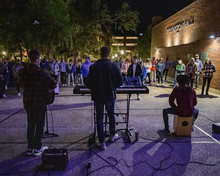 Musicians leading an evening worship gathering outside Turlington Hall