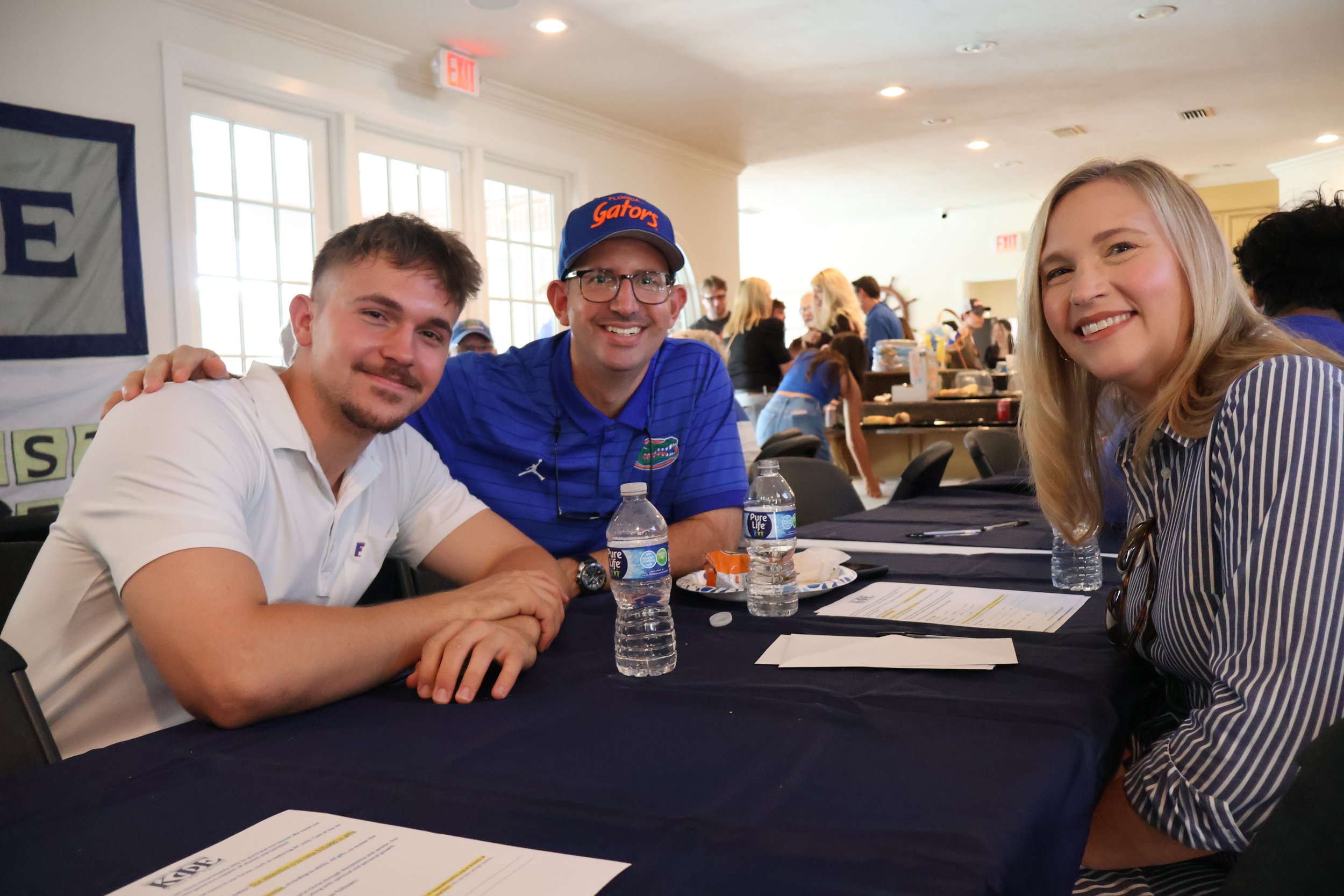 A Kappa Phi brother and family smiling together at a fraternity gathering.