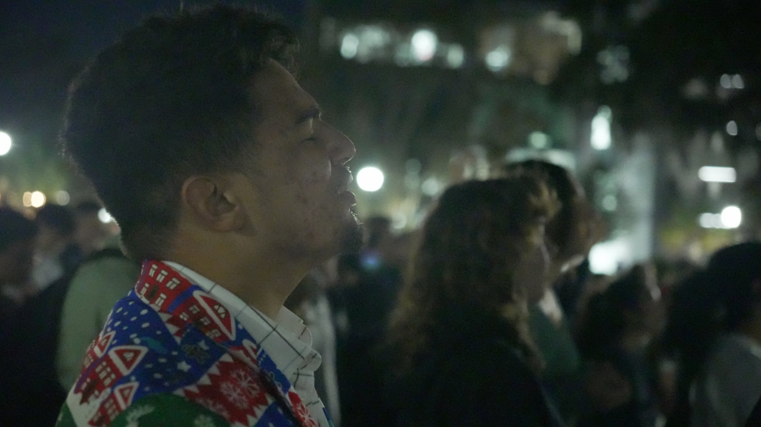 Participants singing during an outdoor evening worship gathering