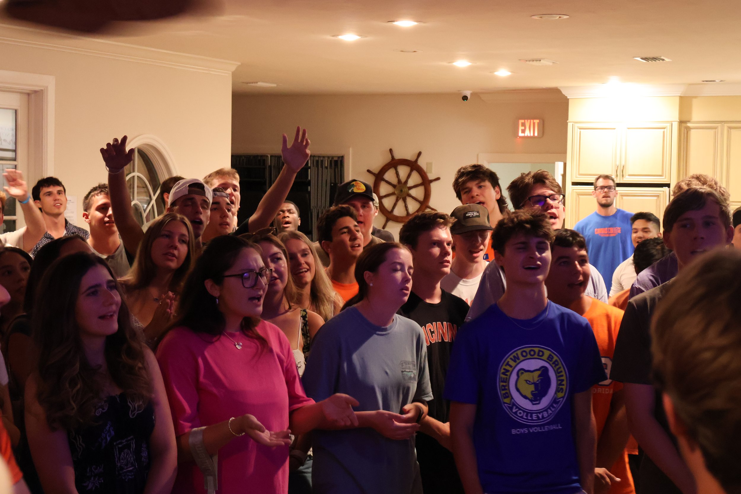 Students singing together at a worship gathering