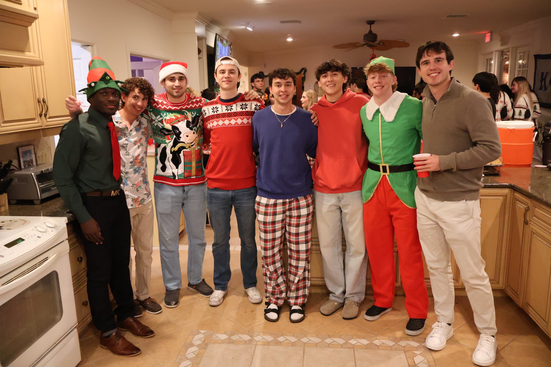 Brothers gathered in festive clothing at the Kappa Phi house
